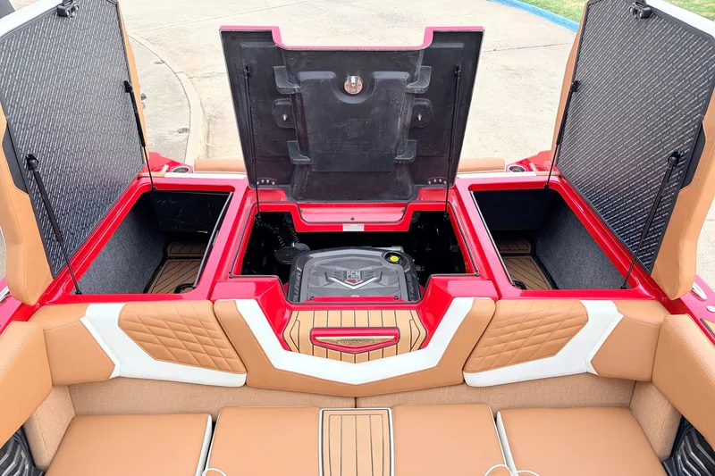Slide: The Image of 2022 Nautique Super Air Nautique G25 engine compartment with open hatches, showcasing storage and design. - 50