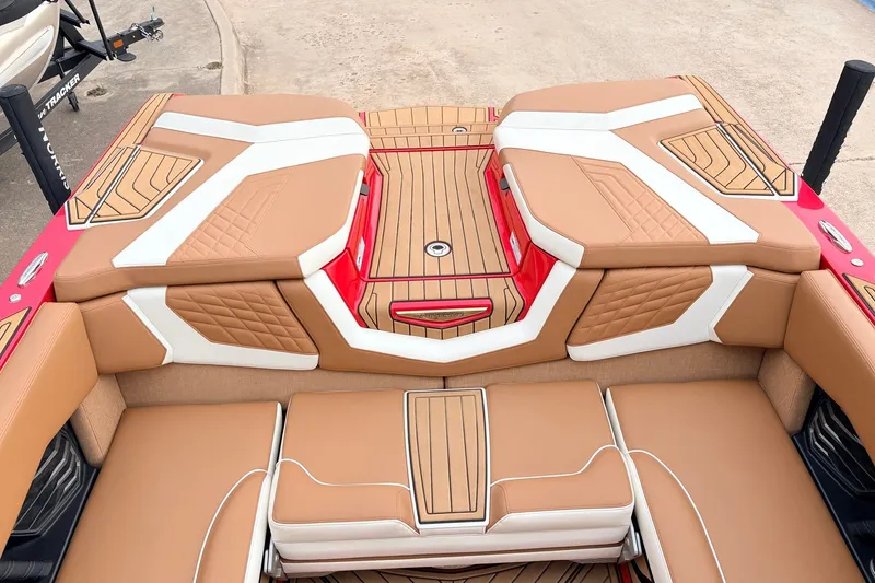 Slide: The Image of 2022 Nautique Super Air Nautique G25 interior with tan and white upholstery. - 43
