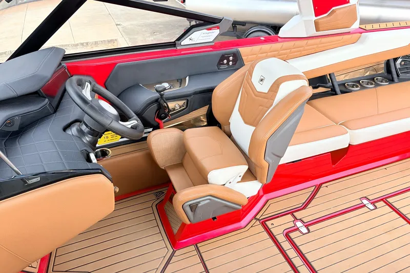 Slide: The Image of 2022 Nautique Super Air Nautique G25 interior with tan and red accents, luxury seating. - 39