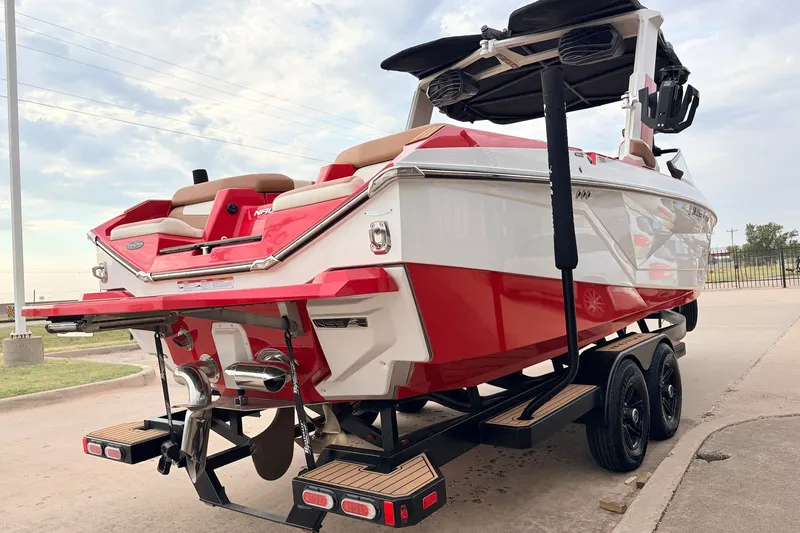 Slide: The Image of 2022 Nautique Super Air Nautique G25 boat on trailer, red and white design. - 5