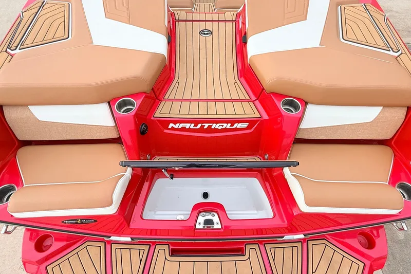 Slide: The Image of 2022 Nautique Super Air Nautique G25 boat interior with tan and red accents. - 57