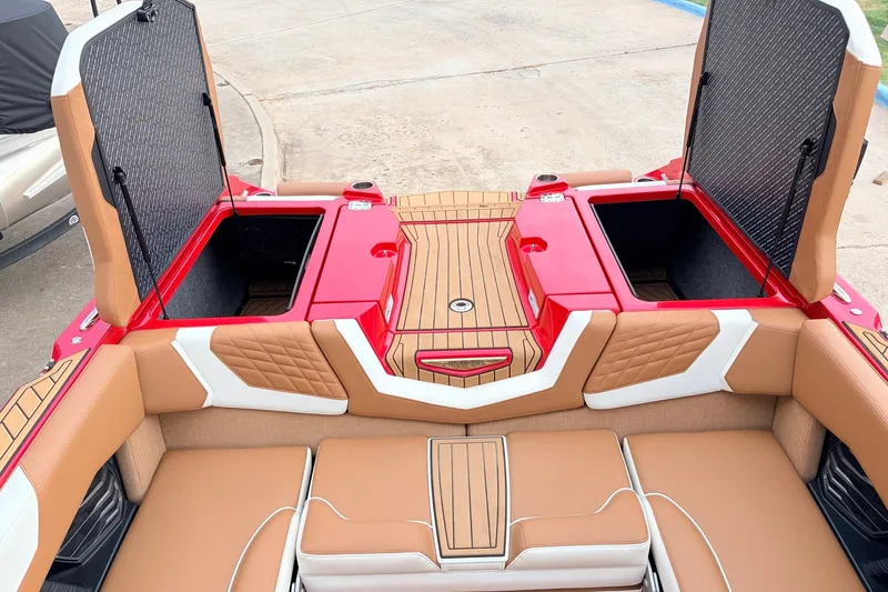 Slide: The Image of 2022 Nautique Super Air Nautique G25 boat interior with open storage compartments. - 48