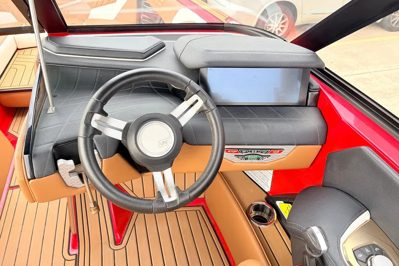 Slide: The Image of 2022 Nautique Super Air Nautique G25 dashboard with steering wheel and touchscreen display. - 40