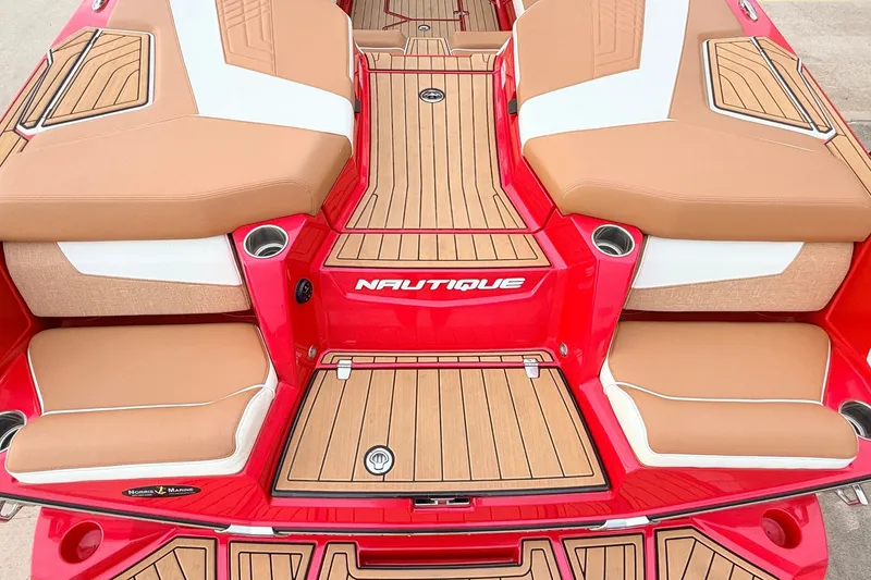 Slide: The Image of 2022 Nautique Super Air Nautique G25 boat interior with tan and white seating. - 56
