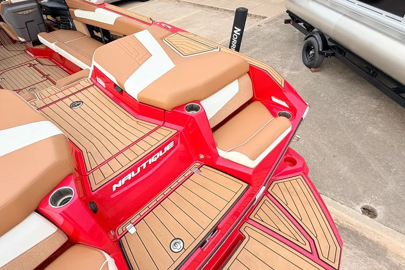 Slide: The Image of 2022 Nautique Super Air Nautique G25 boat interior with red and tan seating. - 55