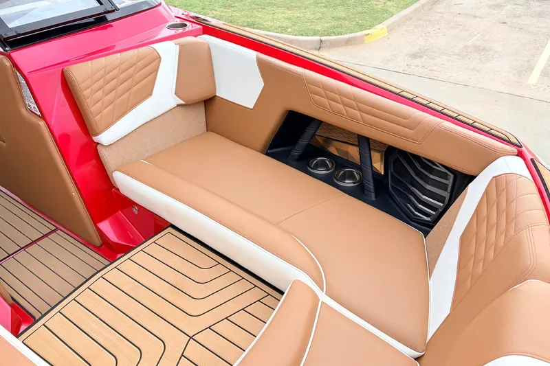 Slide: The Image of 2022 Nautique Super Air Nautique G25 interior with tan and white seating, cup holders. - 16