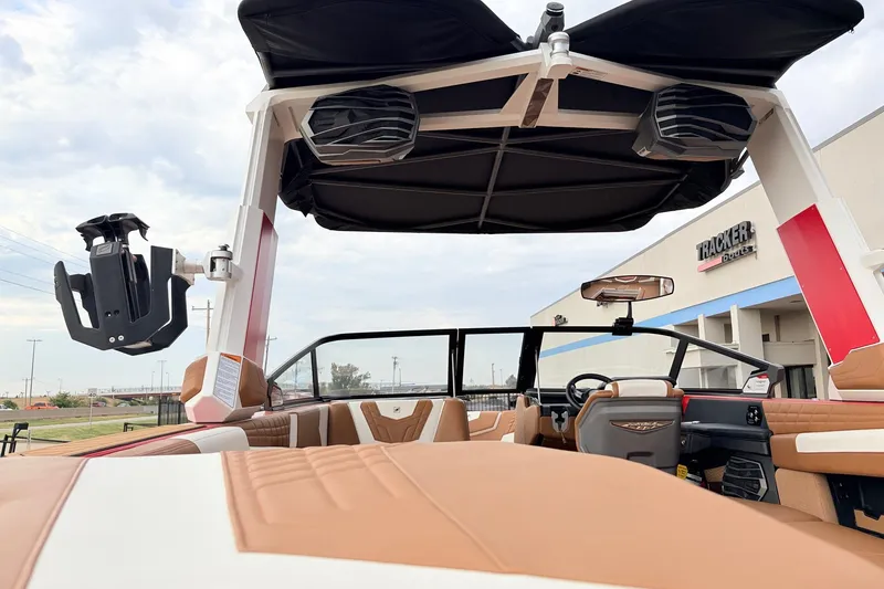 Slide: The Image of 2022 Nautique Super Air Nautique G25 interior with speakers and seating, at a dealership. - 52