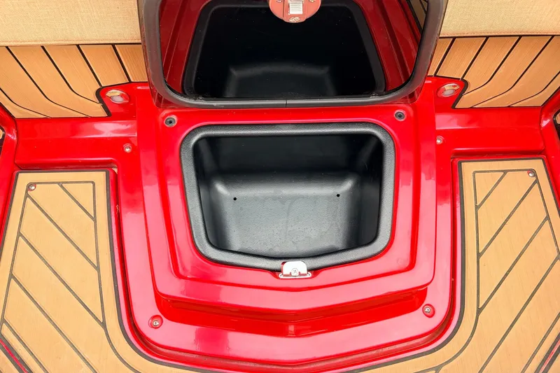 Slide: The Image of Red storage compartment on 2022 Nautique Super Air Nautique G25 boat deck. - 32