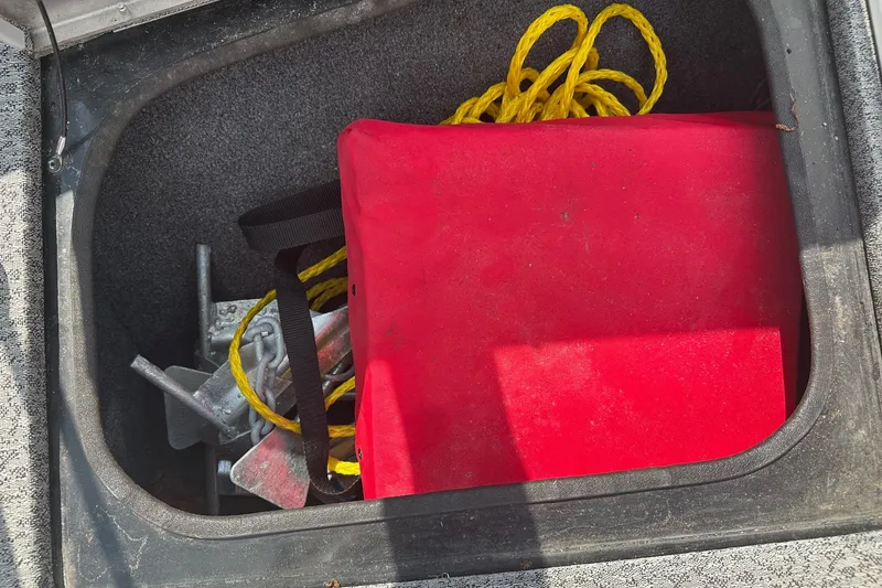 Slide: The Image of Storage compartment in a 2021 Bass Tracker Pro 16 boat with anchor and rope. - 18