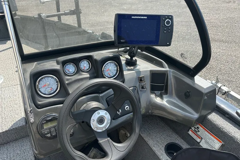 Slide: The Image of 2021 Bass Tracker Pro 16 dashboard with steering wheel and Humminbird Helix 7 fish finder. - 22