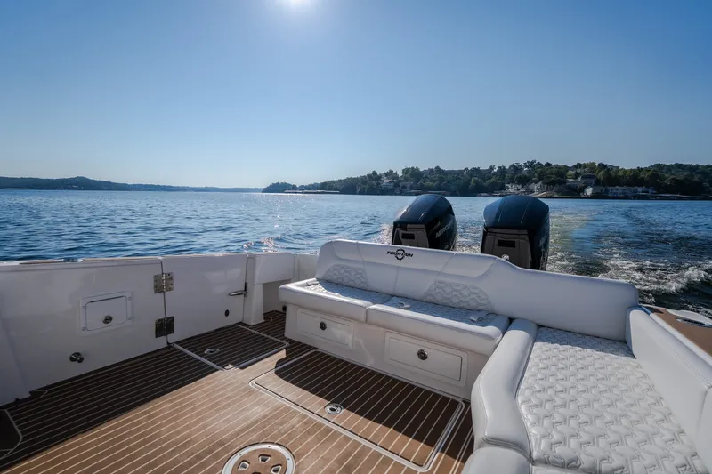 Slide: The Image of Luxury Fountain 39 DX boat interior with twin engines, cruising on a sunny lake, 2026 model. - 20