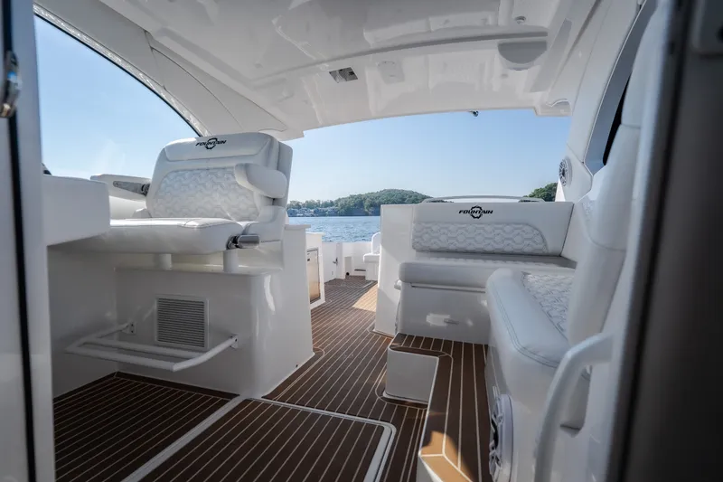Slide: The Image of Interior of 2026 Fountain 39 DX boat with luxurious seating and scenic water view. - 73