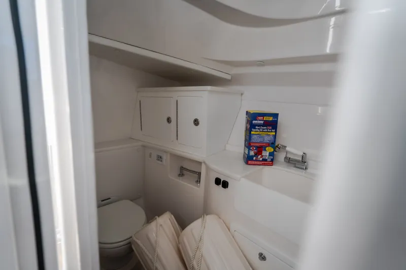 Slide: The Image of Compact bathroom in 2026 Fountain 39 DX boat with storage cabinets and emergency kit. - 77