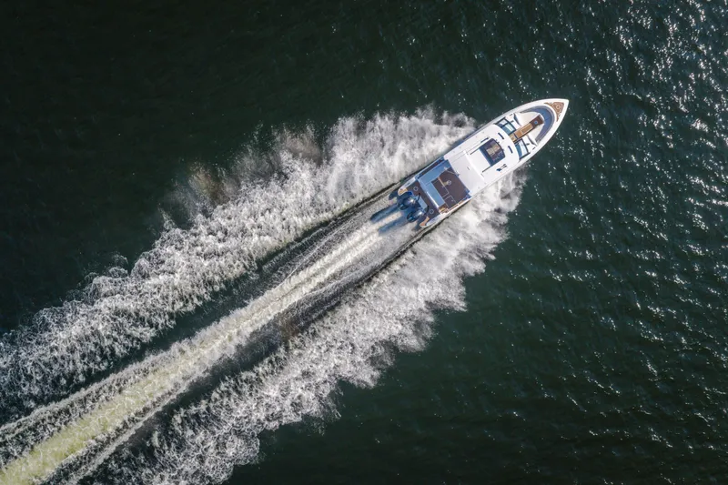 Slide: The Image of Aerial view of 2026 Fountain 39 DX boat speeding on water, leaving a wake. - 81