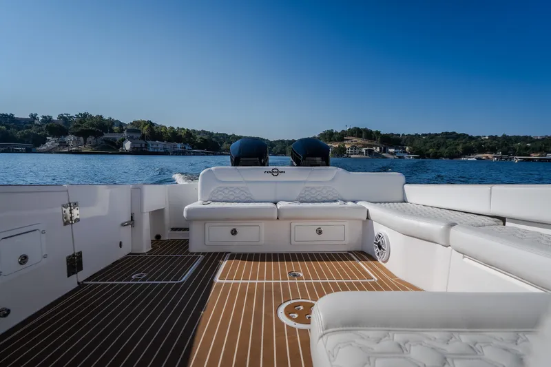 Slide: The Image of Luxury interior of 2026 Fountain 39 DX boat on a serene lake. - 22
