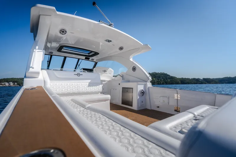 Slide: The Image of Luxurious 2026 Fountain 39 DX boat interior with sleek seating and scenic lake view. - 19