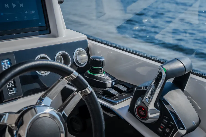 Slide: The Image of Steering console of 2026 Fountain 39 DX boat with modern controls and water view. - 29