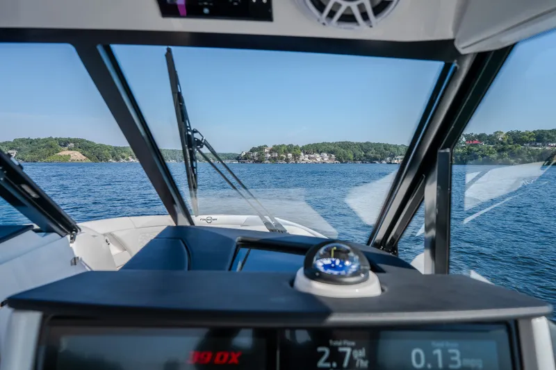 Slide: The Image of Interior view from a 2026 Fountain 39 DX boat, overlooking a scenic lake. - 35