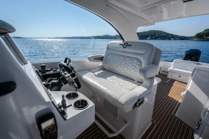 Slide: The Image of Luxurious interior of 2026 Fountain 39 DX boat with plush seating and scenic ocean view. - 36
