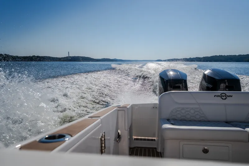 Slide: The Image of 2026 Fountain 39 DX boat cruising on open water with twin Mercury engines. - 50