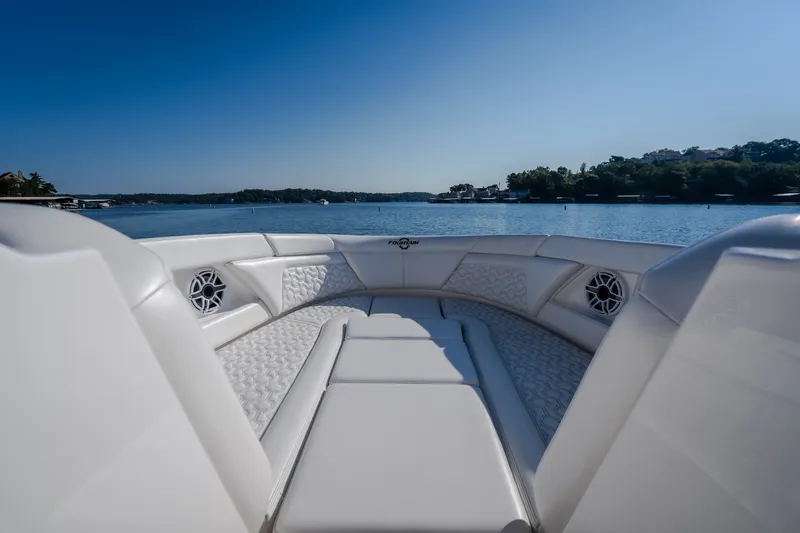 Slide: The Image of Luxurious seating on 2026 Fountain 39 DX boat, overlooking serene lake and clear blue sky. - 62
