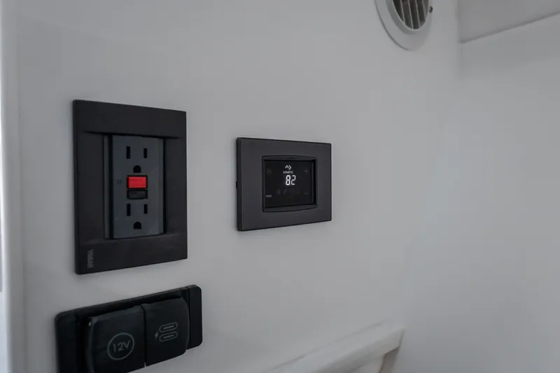 Slide: The Image of Electrical outlet and digital thermostat on Fountain 39 DX, 2026 model. - 76