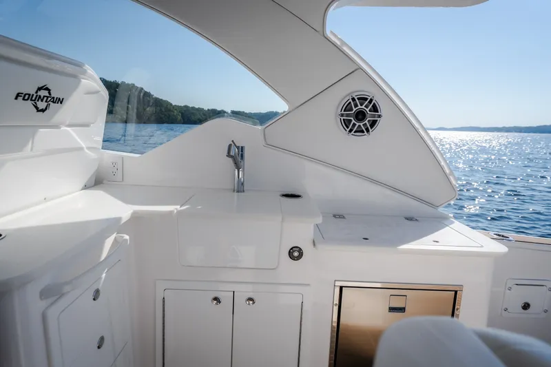Slide: The Image of Interior view of 2026 Fountain 39 DX boat with sleek design and ocean backdrop. - 23
