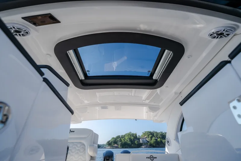 Slide: The Image of Interior view of 2026 Fountain 39 DX boat with sunroof and scenic background. - 72