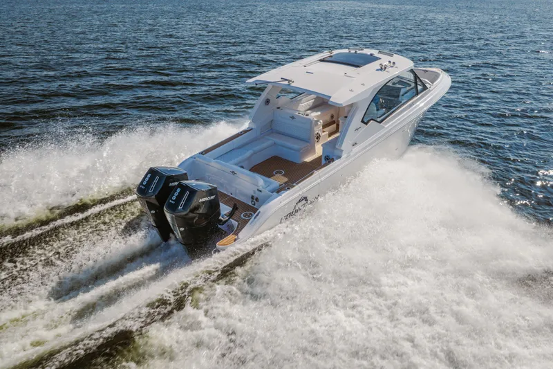 Slide: The Image of 2026 Fountain 39 DX boat cruising on open water with dual Mercury engines. - 80