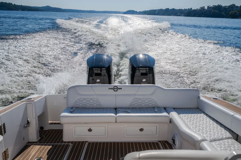 Slide: The Image of 2026 Fountain 39 DX boat cruising on a lake with twin engines. - 46