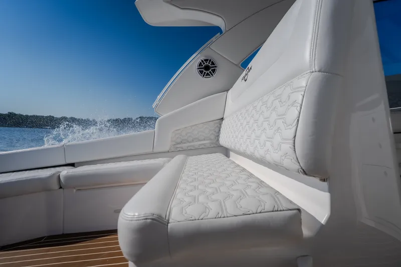 Slide: The Image of Luxurious white seating on 2026 Fountain 39 DX boat, with water splashing in the background. - 21