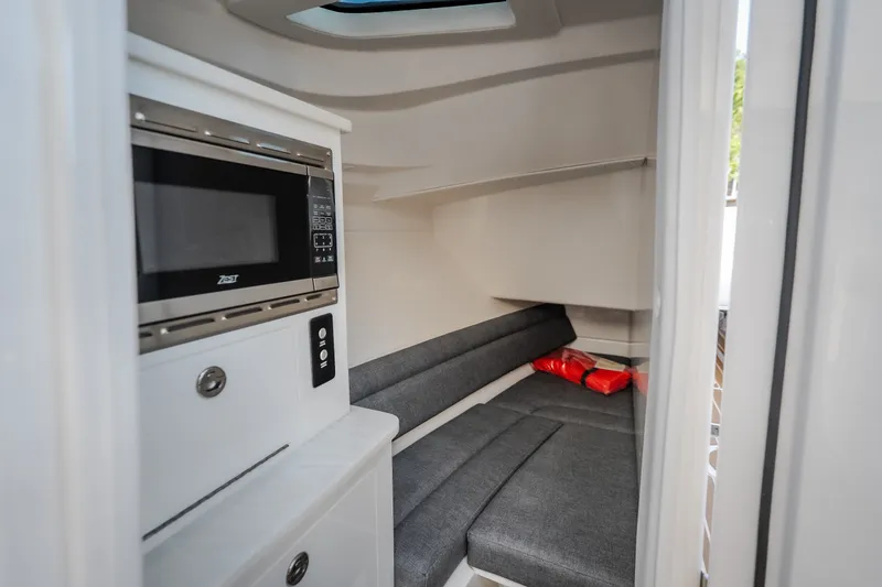 Slide: The Image of Interior of 2026 Fountain 39 DX boat with microwave and seating area. - 75