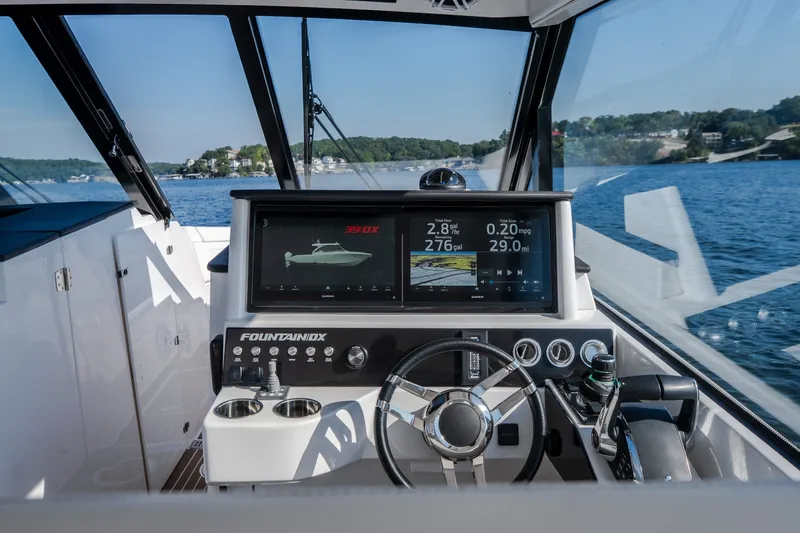 Slide: The Image of Interior view of 2026 Fountain 39 DX boat cockpit with advanced navigation display. - 27