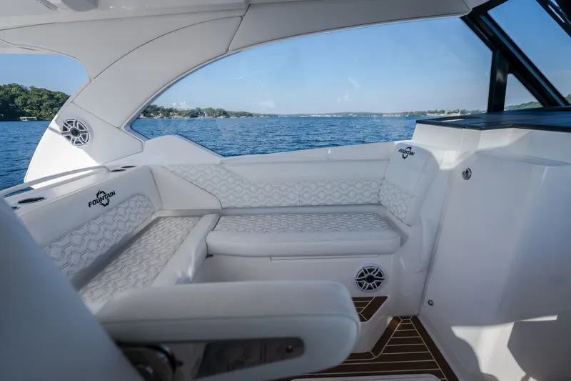 Slide: The Image of Luxurious interior of 2026 Fountain 39 DX boat with white seating and scenic water view. - 58