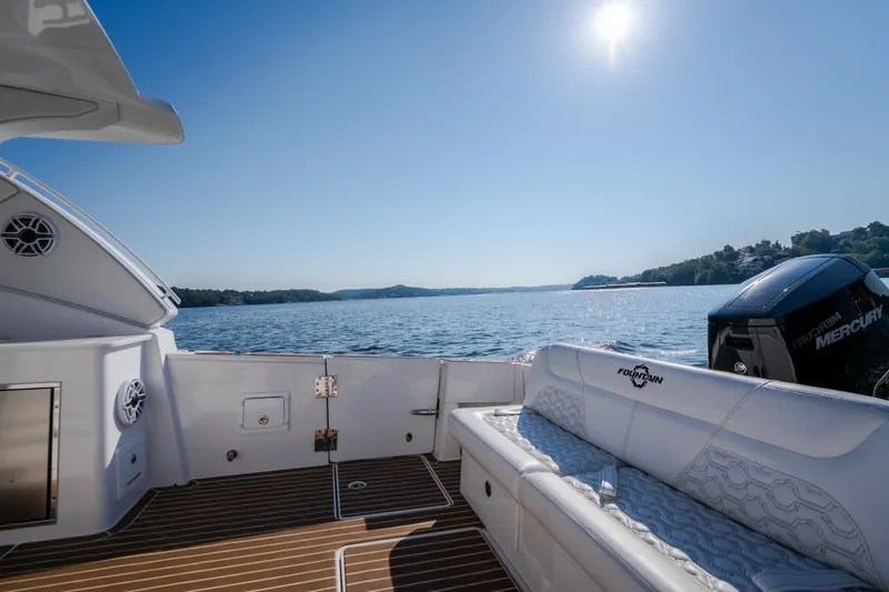 Slide: The Image of Luxurious 2026 Fountain 39 DX boat interior with scenic lake view under clear blue sky. - 42