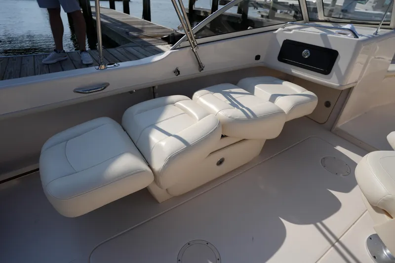 Slide: The Image of 2018 Grady-White Freedom 192 boat interior with white cushioned seating. - 17