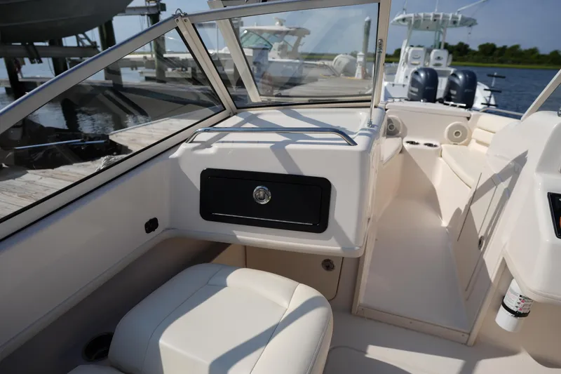 Slide: The Image of 2018 Grady-White Freedom 192 boat interior with seating and storage compartment. - 18