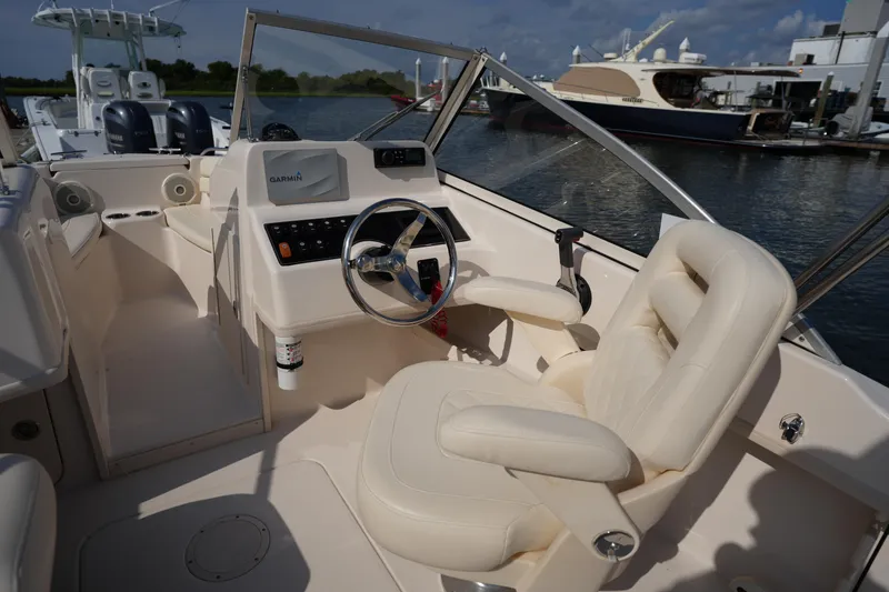 Slide: The Image of 2018 Grady-White Freedom 192 boat interior with steering wheel and plush seating. - 19