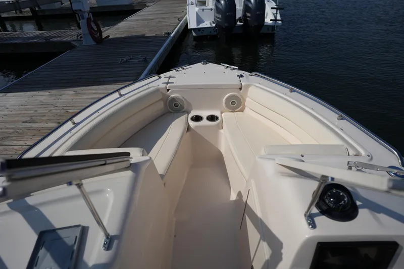 Slide: The Image of 2018 Grady-White Freedom 192 boat interior with seating and cup holders at dock. - 27