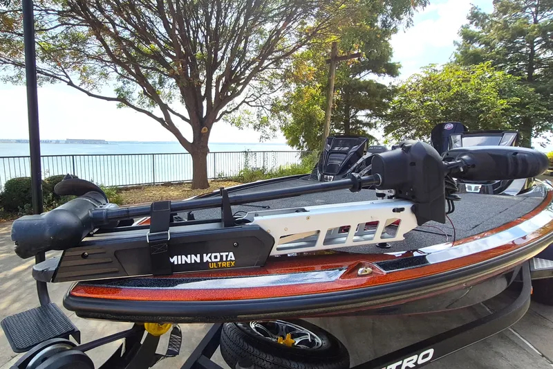 Slide: The Image of 2020 Nitro Z19 Pro boat with Minn Kota Ultrex motor by a lakeside. - 2