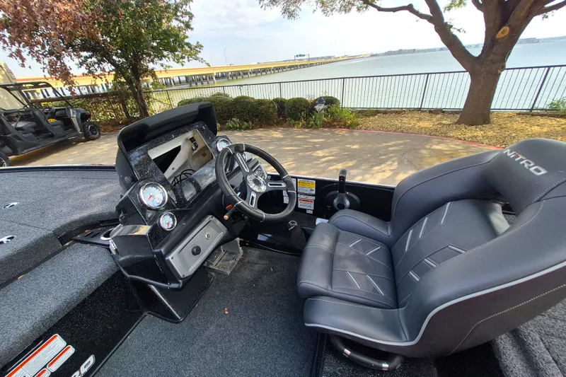 Slide: The Image of Interior of a 2020 Nitro Z19 Pro boat with steering wheel and dashboard by a lakeside. - 11