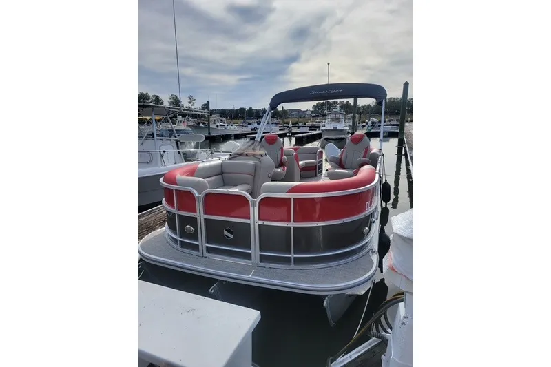 Slide: The Image of 2021 South Bay RSLE Tri Toon pontoon boat docked at marina. - 2