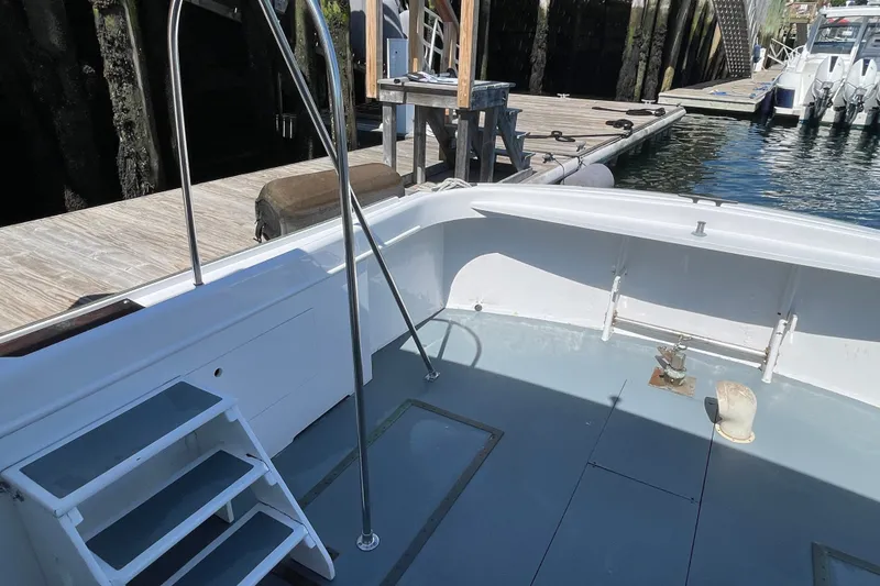 Slide: The Image of 1966 Webbers Cove 34 boat docked, featuring a clean deck and sturdy railing. - 24