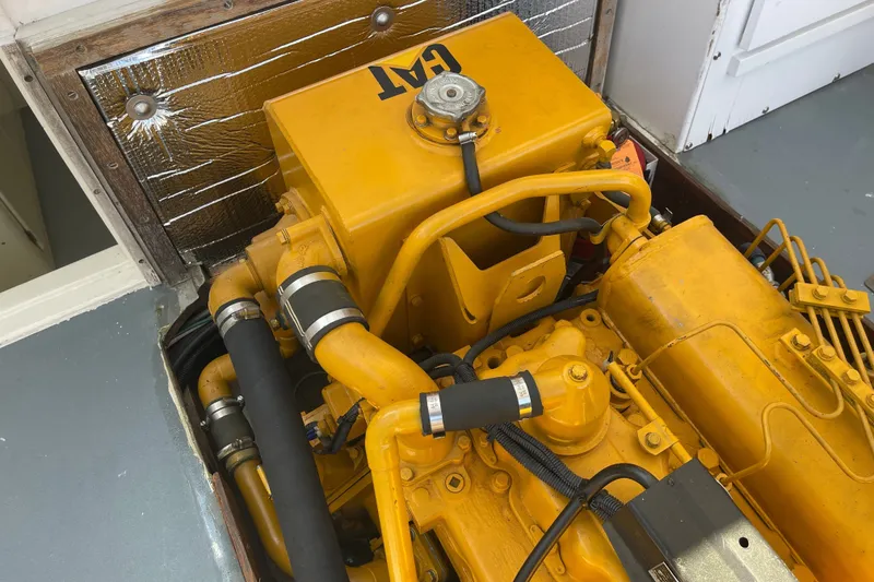 Slide: The Image of Yellow CAT engine in a 1966 Webbers Cove 34 boat, showcasing detailed mechanical components. - 51
