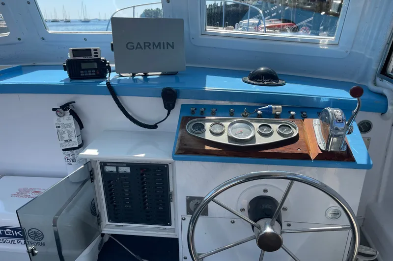 Slide: The Image of Helm of a 1966 Webbers Cove 34 boat with navigation equipment and steering wheel. - 33