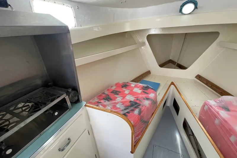 Slide: The Image of Interior of 1966 Webbers Cove 34 boat with stove and sleeping area. - 41