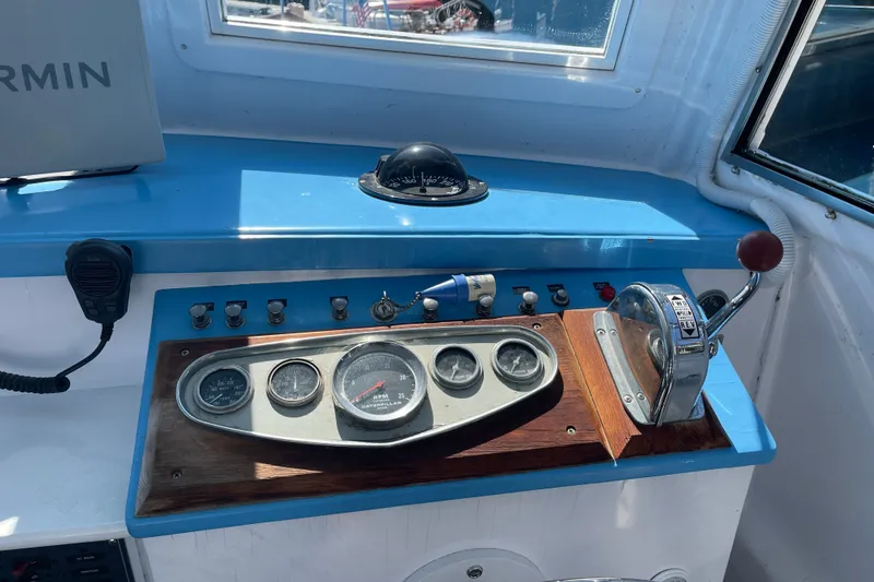Slide: The Image of Helm of a 1966 Webbers Cove 34 boat with gauges and controls. - 35