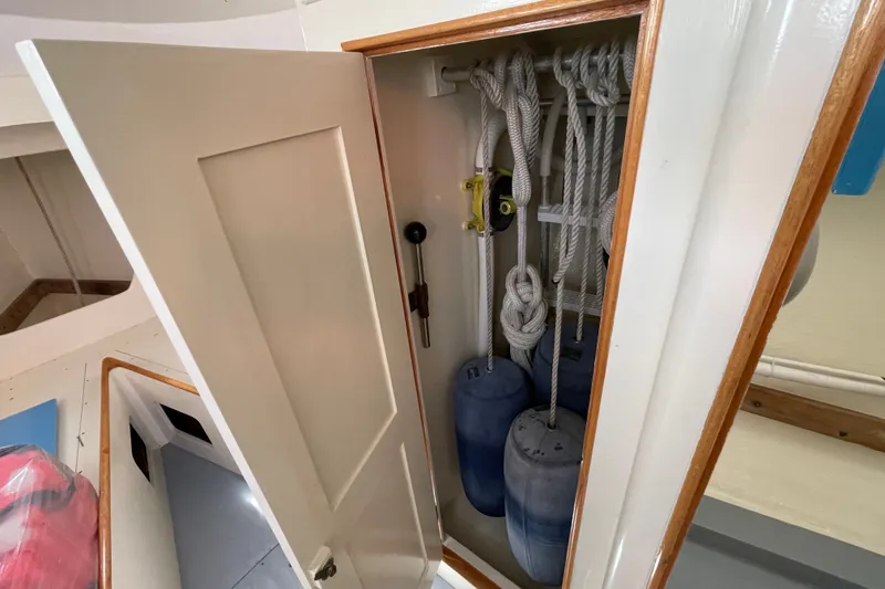 Slide: The Image of Storage compartment on a 1966 Webbers Cove 34 boat with ropes and fenders. - 44