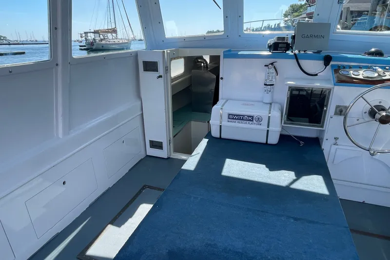 Slide: The Image of Interior of a 1966 Webbers Cove 34 boat, featuring navigation equipment and marine rescue platform. - 28