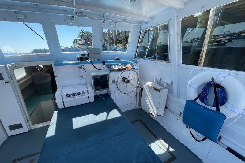 Slide: The Image of Interior of a 1966 Webbers Cove 34 boat with steering wheel and navigation equipment. - 30